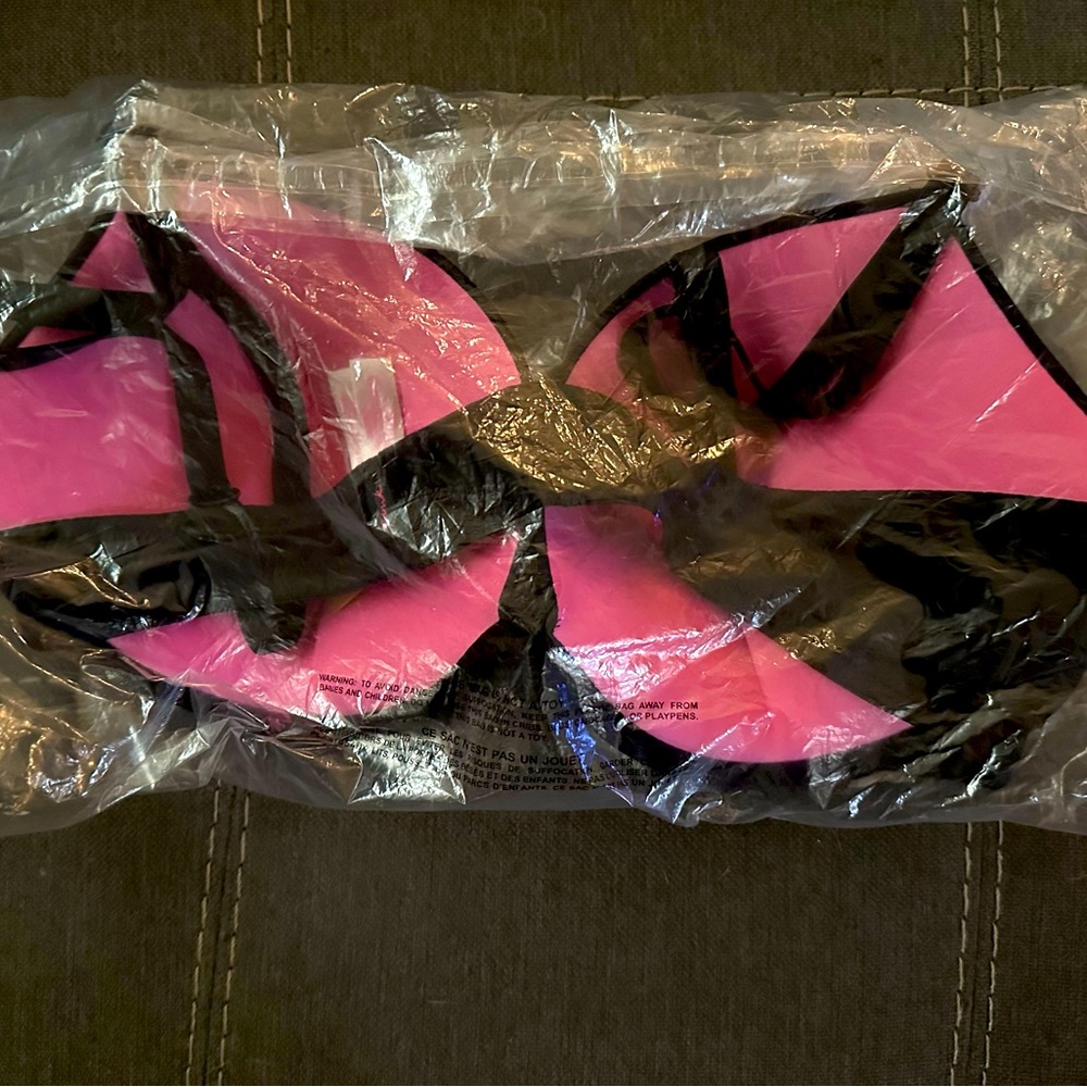 Victoria’s Secret 38C black bra with pink cups. Never worn in original bag.